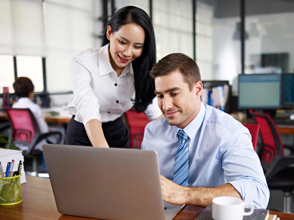 Business man and woman looking at a laptop