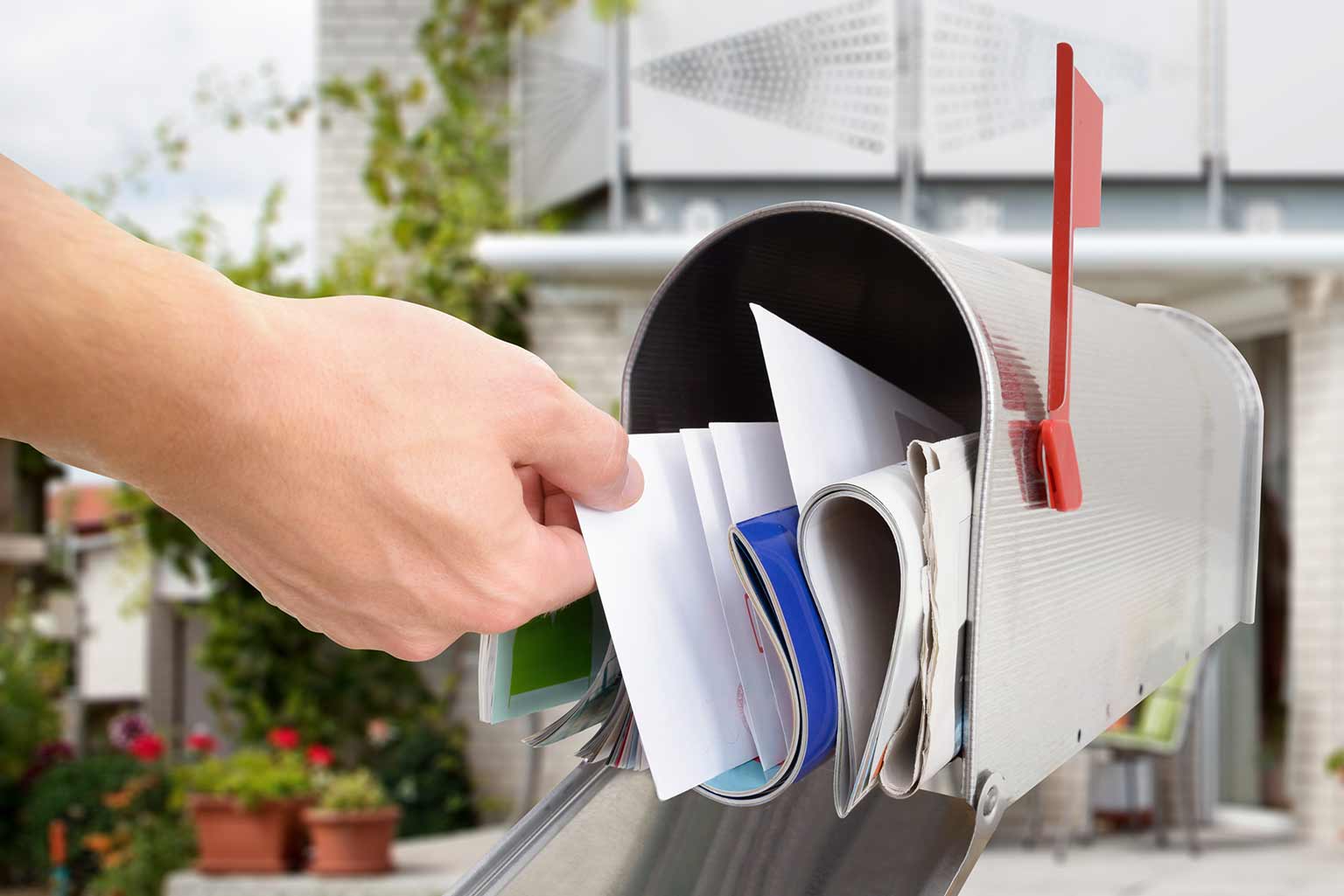 person grabbing mail from mailbox